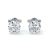 A pair of 14k gold diamond stud earrings with a 4-claw setting