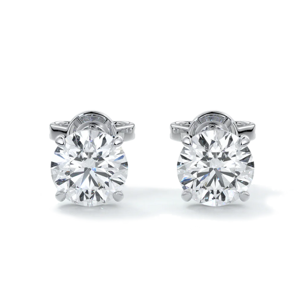 A pair of 14k gold diamond stud earrings with a 4-claw setting